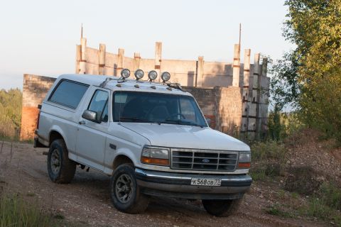 1993 Ford Bronco - This 1993 Ford Bronco is parked on a dirt road near some unfinished concrete structures.