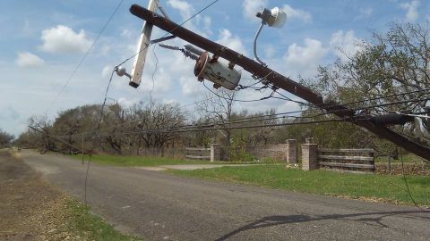 1996 Ford Bronco - A downed utility pole lies across a road, with a transformer and electrical wires visible.