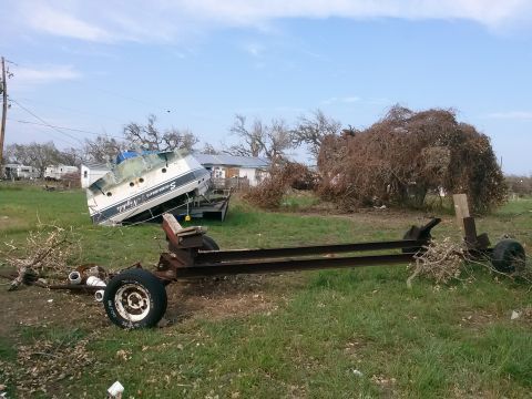 1996 Ford Bronco - Boat named 'Summer Nights' overturned on a trailer, with a damaged trailer frame nearby.