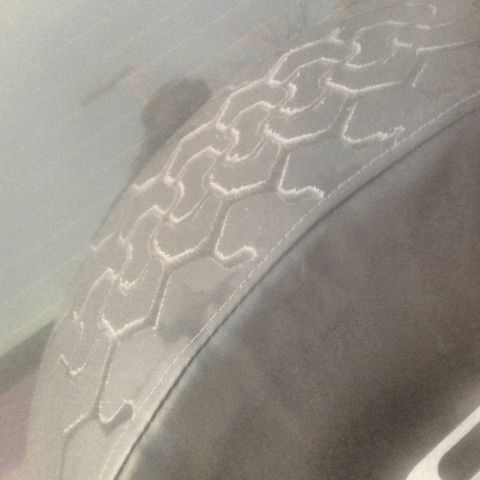 1996 Ford Bronco - Close-up of a spare tire cover a distinctive hexagonal tread pattern. The Supermotors.net logo is visible in the lower right corner.