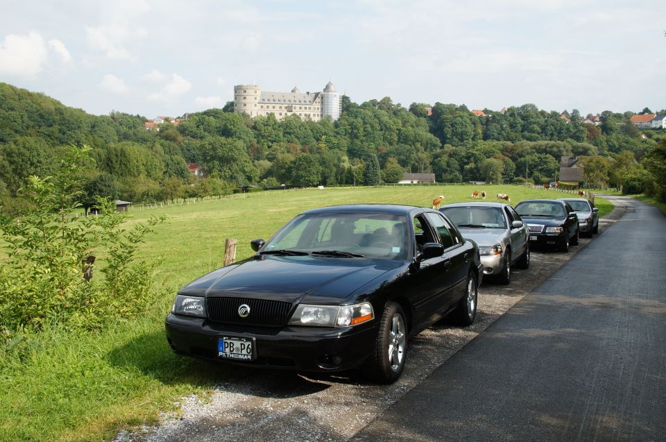 Black 2003 Mercury Marauder parked roadside with a castle in the background