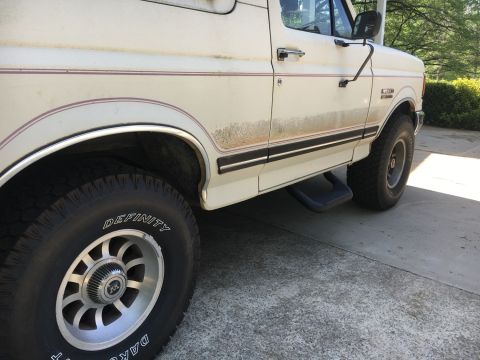 1988 Ford Bronco - Side profile of a 1988 Ford Bronco, showing its body lines and wheels.