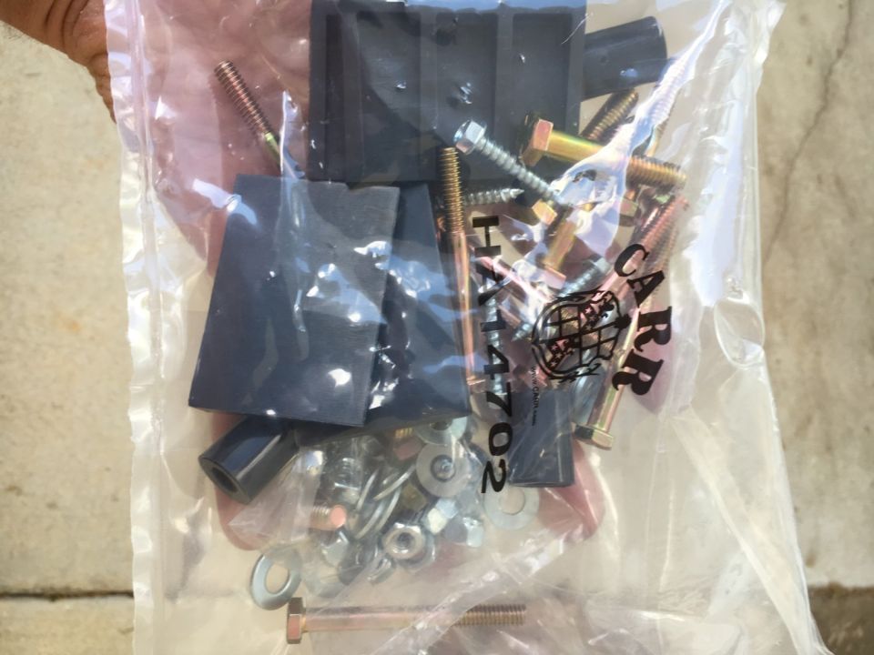 Bag of assorted bolts, nuts, washers, and black rubber or plastic components