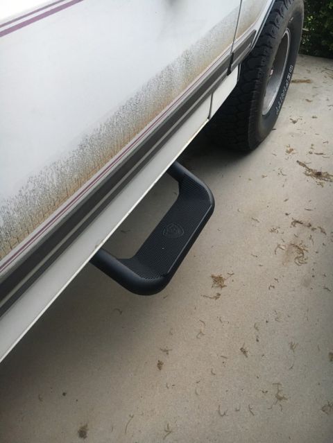 1988 Ford Bronco - Close-up view of the side step on a white 1988 Ford Bronco.