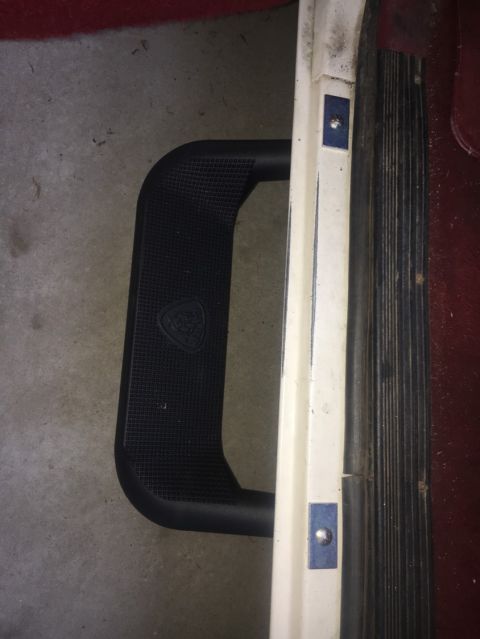 1988 Ford Bronco - Close-up of a vehicle's interior step and door trim.