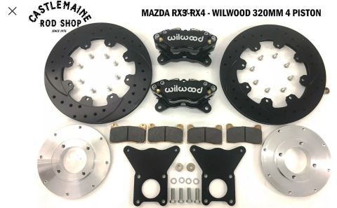 1973 Mazda RX-3 - A Wilwood 320mm 4 piston brake kit for Mazda RX3-RX4 models, including rotors, pads, and mounting hardware.
