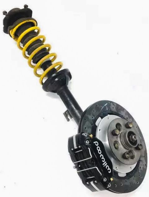 1973 Mazda RX-3 - Front brake assembly with Wilwood caliper and yellow coilover shock.