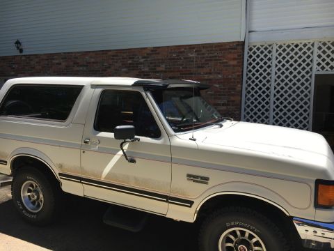 1988 Ford Bronco - This 1988 Ford Bronco is shown from the front three-quarter view, parked outside a building.