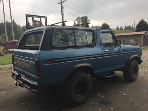 1979 Ford Bronco - Ford Bronco with custom rear bumper and roof rack parked outdoors.
