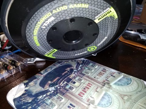 1994 Ford Bronco - Car audio subwoofer and a book with the Library of Congress on its cover.