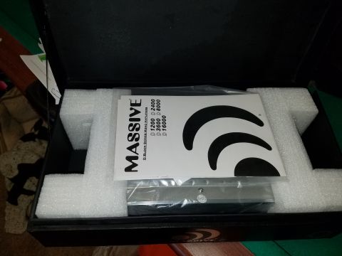 1994 Ford Bronco - A car stereo amplifier is shown inside its packaging with protective foam and documentation.
