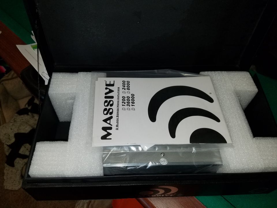 Car stereo amplifier in a box with foam padding and instruction manual