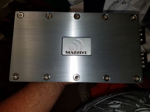 1994 Ford Bronco - A car amplifier with the brand name 'MASSIVE' is shown, held by a person's hand.