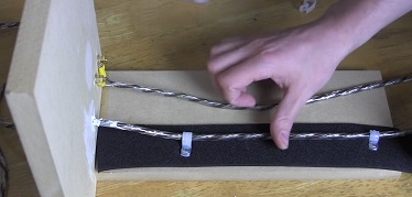 1994 Ford Bronco - Speaker wire installation on a wooden mounting board.