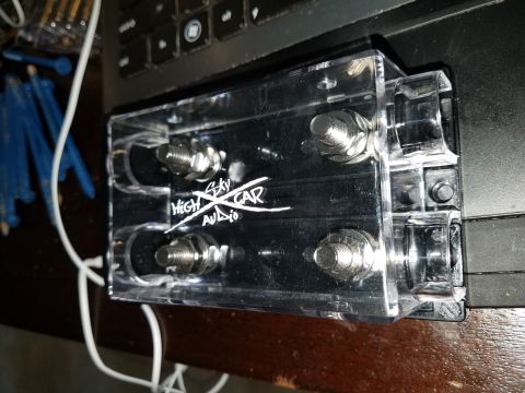 1994 Ford Bronco - A clear power distribution block with the 'HIGH SKY CAR AUDIO' branding is shown, four large bolts for connections.