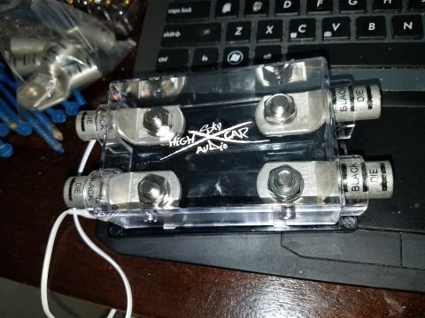 1994 Ford Bronco - A car audio power distribution block with "High Sky Car Audio" branding is shown on a surface.