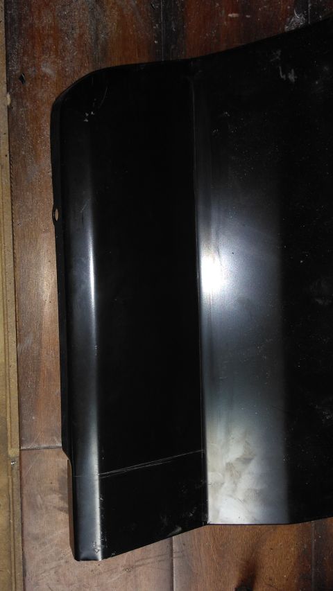 1996 Ford Bronco - A close-up view of a black bumper corner, showing distinct seam lines and a slightly scuffed surface.
