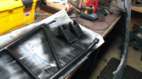 1996 Ford Bronco - Parts are laid out on a workbench, possibly for a vehicle restoration project.