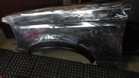 1996 Ford Bronco - A bare metal fender shows signs of bodywork and primer, indicating repairs or preparation for painting.