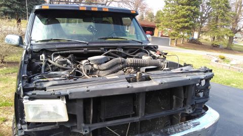 1996 Ford Bronco - Front view of a 1996 Ford Bronco with the hood open, revealing the engine and surrounding components.
