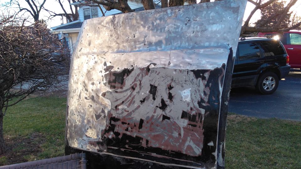 Taking the paint off the hood. Luckily there weren't many dents so body filler was nice. If you're wondering why I stripped to bare metal for the whole truck, take a few steps back and look at that passenger side fender again.