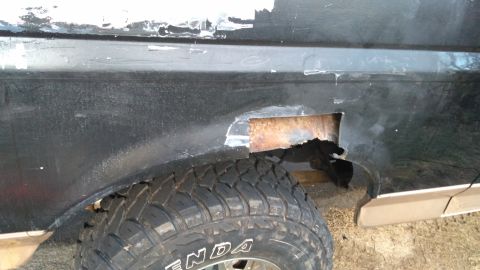 1996 Ford Bronco - Rear quarter panel of a 1996 Ford Bronco exhibits significant rust and body damage.
