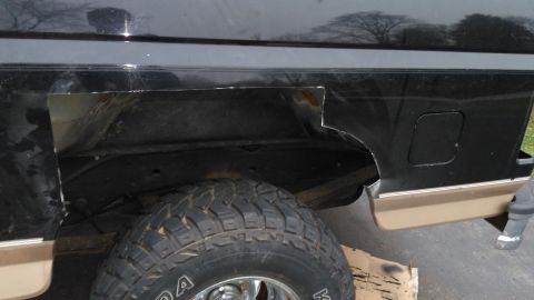 1996 Ford Bronco - This SUV's rear quarter panel shows significant rust and damage, with a section cut out.