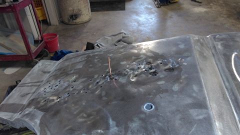 1996 Ford Bronco - Hood of a vehicle undergoing repair, showing significant rust damage.