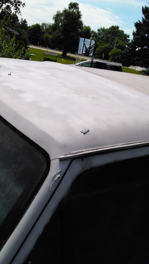 1996 Ford Bronco - Car roof with primer applied, detailing damage on the A-pillar and roof edge.