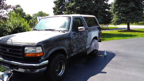 1996 Ford Bronco - This Ford Bronco is in the process of being prepped for paint, with primer visible on the body panels.
