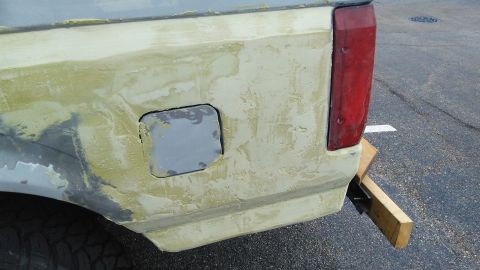 1996 Ford Bronco - This vehicle's rear quarter panel is covered in body filler and primer, obscuring its original year and model.