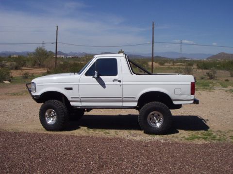 1993 Ford Bronco - This lifted 1993 Ford Bronco is shown in a side profile against a desert landscape.