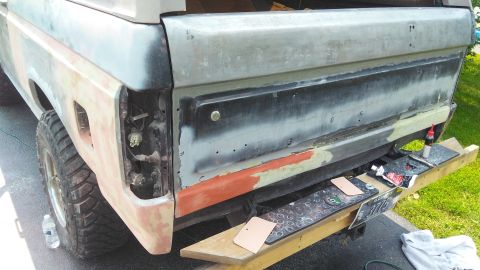 1996 Ford Bronco - The rear of a Ford Bronco, likely from the 1980s, is shown with bodywork in progress, including primer and filler.