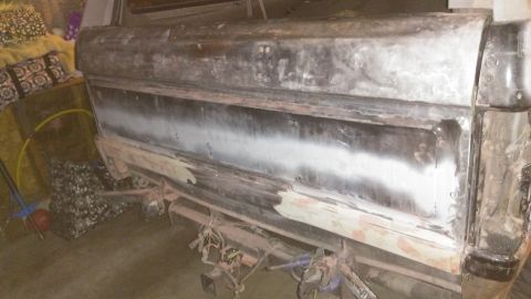 1996 Ford Bronco - Rear quarter panel of a 1996 Ford Bronco undergoing bodywork and paint preparation.