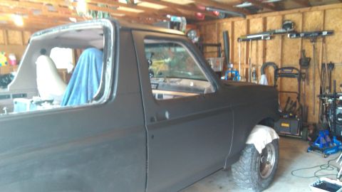 1996 Ford Bronco - This Ford Bronco is undergoing work in a garage, with its roof section removed and seats covered.