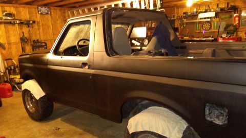 1996 Ford Bronco - Side view of a 1996 Ford Bronco undergoing body work in a garage.