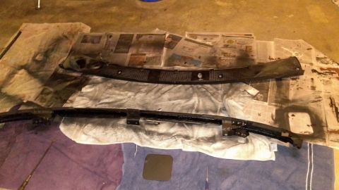 1996 Ford Bronco - Car parts are laid out on newspaper and drop cloths, suggesting a painting or restoration project.