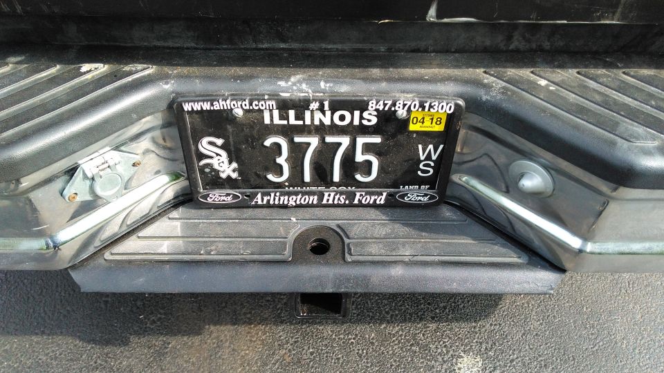 Rear bumper with Illinois license plate 3775 and a trailer hitch