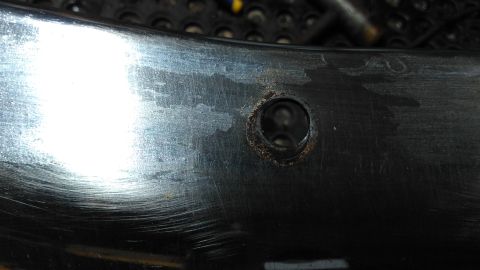 1996 Ford Bronco - Chrome bumper section with a hole, likely for a mounting bolt or bracket.