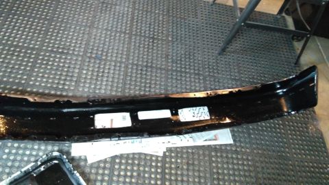 1996 Ford Bronco - A black front bumper is shown from an angled perspective, placed on a textured mat.