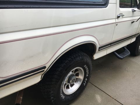 1988 Ford Bronco - This 1988 Ford Bronco is shown from the side, highlighting its wheel and step bar.
