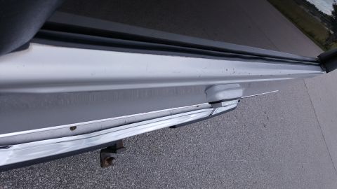 1995 Ford Bronco - Close-up of a vehicle's rear bumper corner with a tow hitch receiver visible.