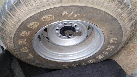 1995 Ford Bronco - Close-up of a tire and wheel assembly, showing brand markings and a metal rim.