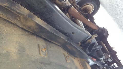1995 Ford Bronco - Underside view of vehicle components, including frame and exhaust system, with visible signs of wear and tear.