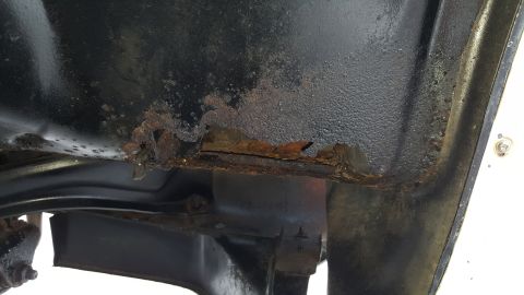 1995 Ford Bronco - Significant rust damage is visible on the frame of the vehicle.