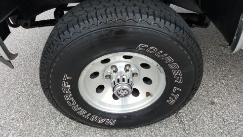 1995 Ford Bronco - A close-up view of a vehicle's tire and wheel assembly, showing the tire tread and rim details.