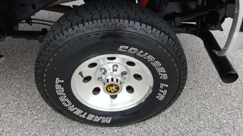 1995 Ford Bronco - Close-up of a vehicle's tire and wheel assembly, showing aftermarket modifications.