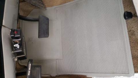 1995 Ford Bronco - Interior view of vehicle floor with pedals and brake release lever visible.