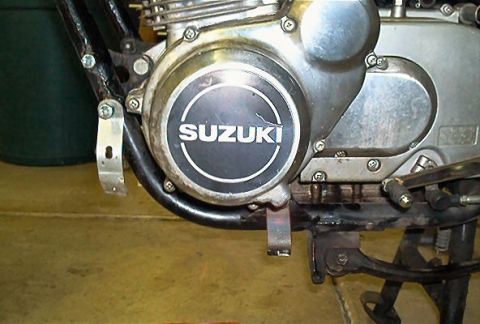 1985 Ford Crown Victoria LTD - Detail of a Suzuki motorcycle engine, showing the brand name on the cover.