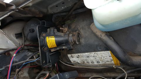 1995 Ford Bronco - Close-up view of engine bay components including a jack and fluid reservoir.